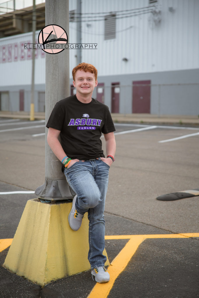 guy senior session in kentucky by klem photography kentucky senior photographer. guy is wearing asbury eagles tshirt  and jeans. He has wavy red hair