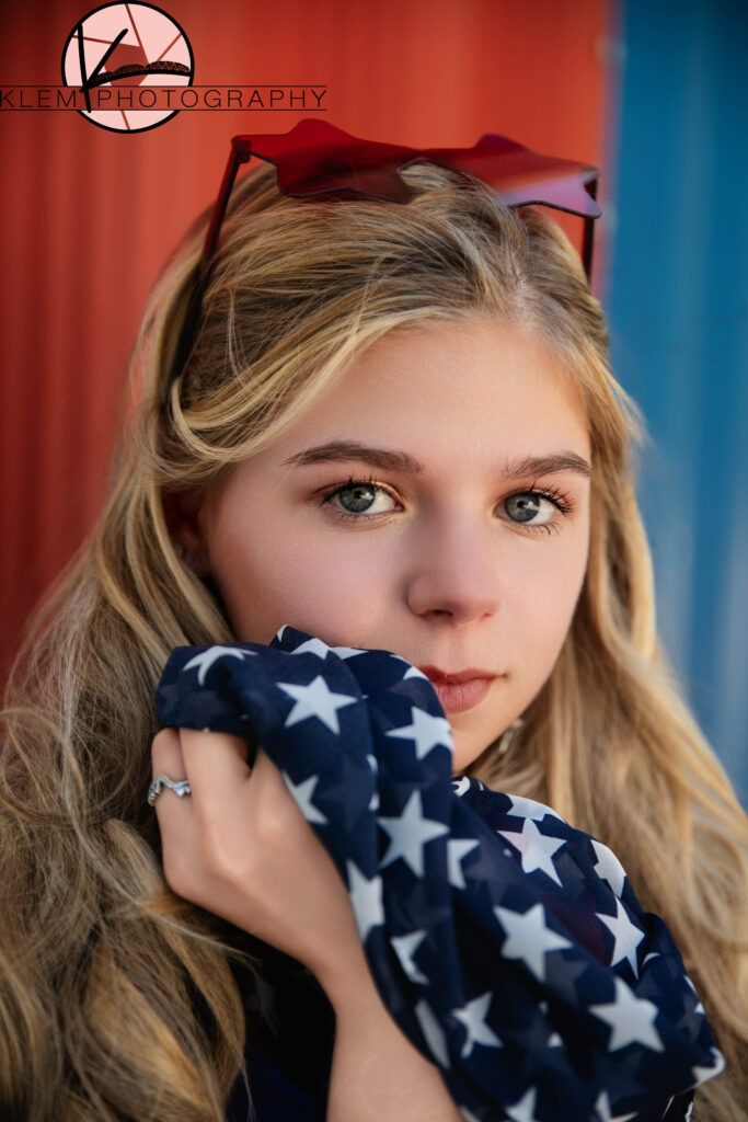 Close-up of senior girl with patriotic makeup and accessories for senior pictures near Evansville. by evansville photographers