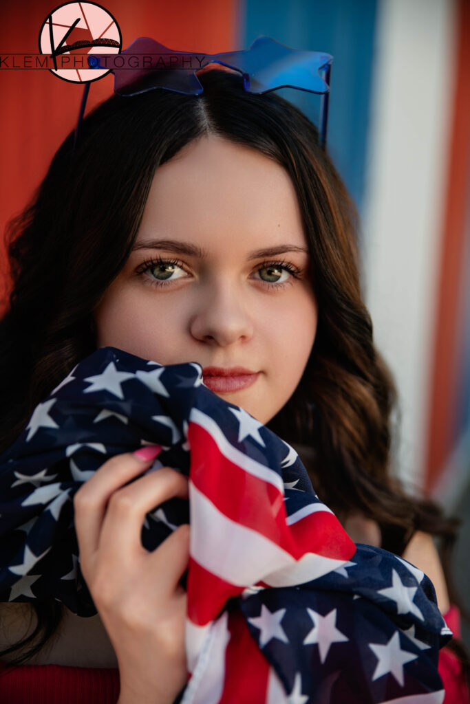 Close-up of senior girl with patriotic makeup and accessories for senior pictures near Evansville. by evansville photographers