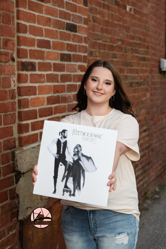 Castle High School Newburgh Indiana senior pictures with Klem photography girl holding fleetwood mac album and smiling 